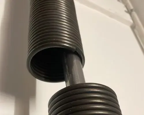 Close-up of a garage door torsion spring